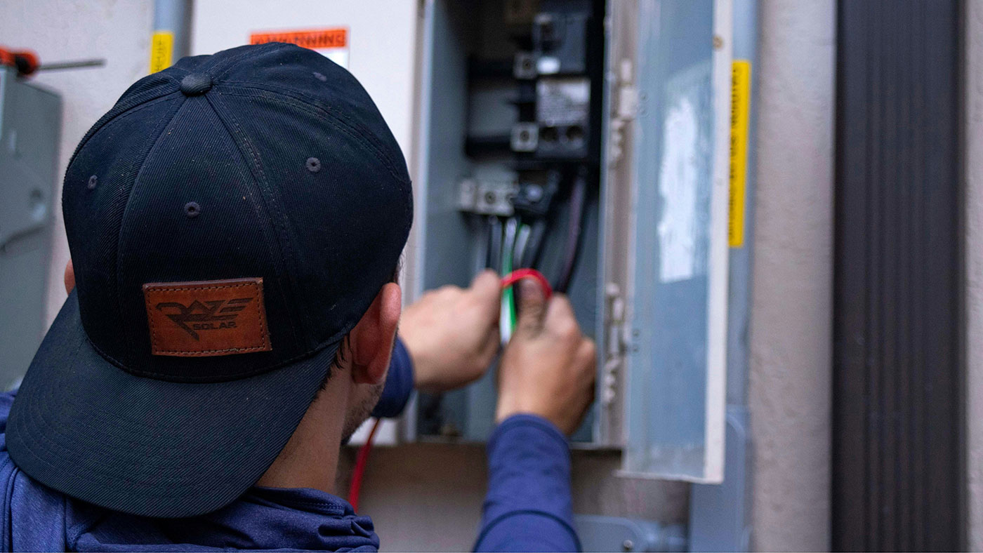 Electrician working on an electrical panel